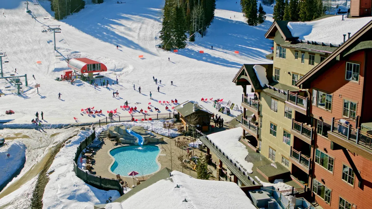 This dynamic scene shows snow-covered ski slopes bustling with activity, a sparkling lodge-side swimming pool, and groups of people enjoying both skiing and post-slope leisure. The image conveys energy, community, and festive winter fun.